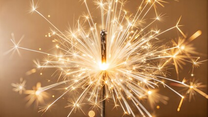 Fototapeta premium Close-up of a sparkling sparkler burning brightly against a golden background
