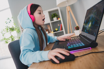 Photo of shocked cute adorable girl little user playing video game alone indoors house