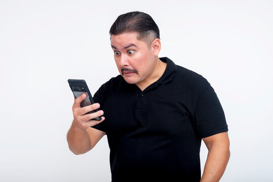 A middle aged man, while looking at his phone, stunned at controversial social media posts from a friend. Set against a white background.