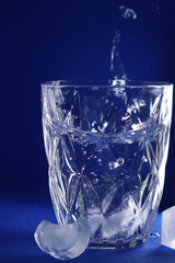 different cold ice cubes on a blue background