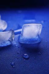 different cold ice cubes on a blue background