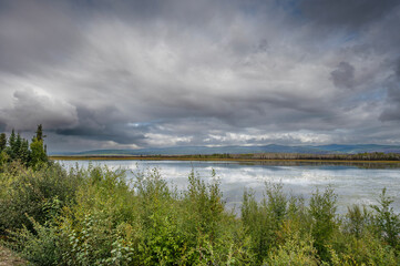 Fototapeta premium Clouds over Gravel Lake in the Yukon Territory, Canada