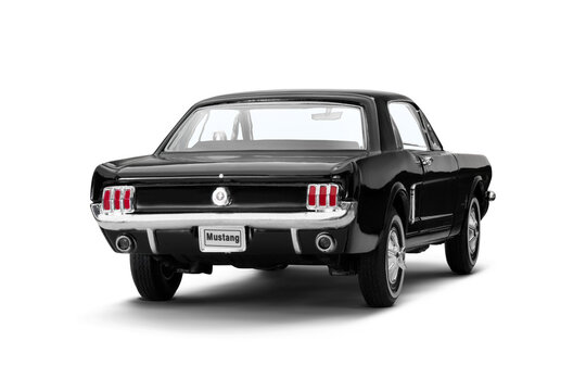 A rear right-side view of a black Ford Mustang 260 model toy car photographed on a transparent background, showcasing its classic design and details