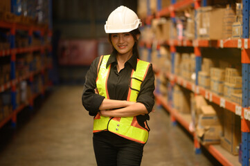 Woman with a container box, logistics engineering of the transportation industry, import-export, transportation engineer, female safety, holding a paper clipboard, standing beside