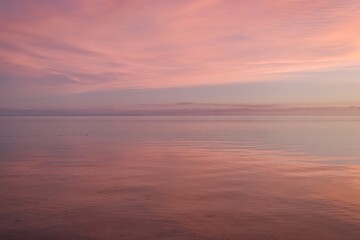 Deep purple sky reflecting in the sea. Full purple sky with almost no horizon. Stunning evening sky just after sunset. Yasawa Islands natural beauty. Fiji beautiful sunset scene. Invisible horizon. 