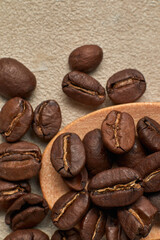 Roasted coffee beans on a wooden spoon