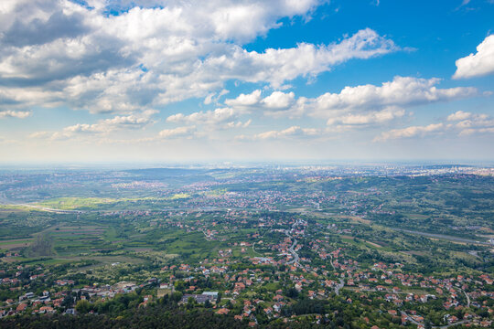 A city view with a blue sky and clouds