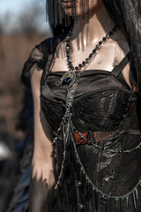 Naklejka premium Goddess of death with black wings on a dried field