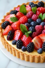 A fresh fruit tart with a golden crust, filled with pastry cream and topped with a colorful assortment of berries