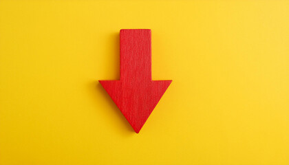 Red wooden arrow pointing down on yellow background. Business, market decline or economic