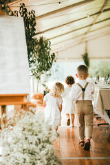 Young bridal party walking through a venue before anyone is seated.