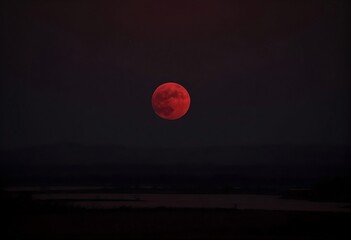 "Eerie Crimson Horizon: Red Moon at Dawn"
