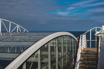Breathtaking panoramic ocean views from outdoor deck of modern cruiseship cruise ship liner Queen Anne sailing at sea with blue sky and clouds