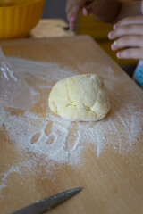 A lump of dough lies on the flour.
