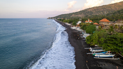 Black sand beach and traditional fishermen boats at the coast of Amed village, Karangasem district...
