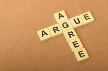the contrast between arguing and agreeing, with the letters forming the words 
