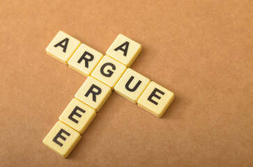 the contrast between arguing and agreeing, with the letters forming the words 
