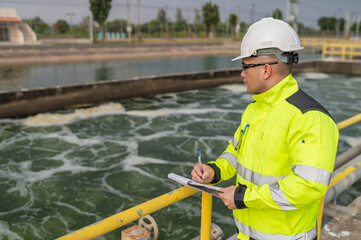 Fototapeta premium Environmental engineers work at wastewater treatment plants,Water supply engineering working at Water recycling plant for reuse