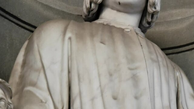 Vertical tilt up of Lorenzo de Medici statue by Gaetano Grazzini in Uffizi Gallery, Florence, Tuscany, Italy
