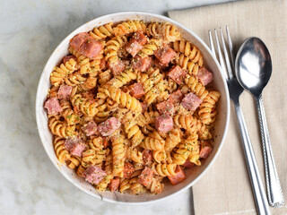 rotini  pasta with  diced spam  and seasoning