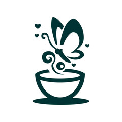 a green cup with a butterfly on it and a bowl of flowers in the background.