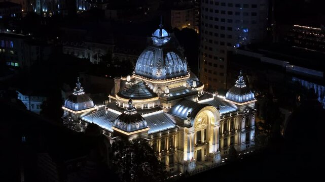 Aerial drone view of the Palace of the Deposits and Consignments illuminated in Bucharest, Romania at night