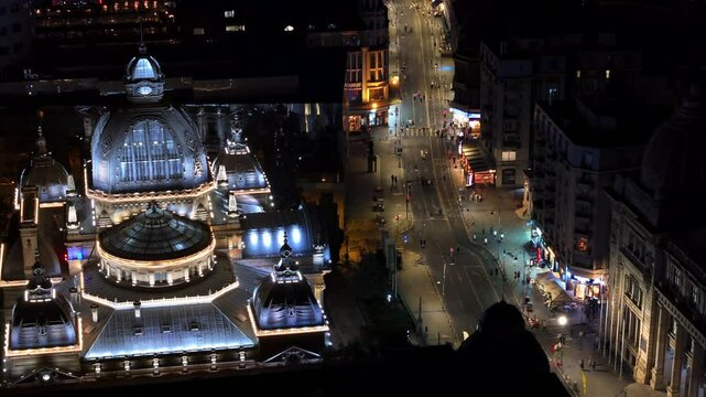 Aerial drone view of the Palace of the Deposits and Consignments illuminated in Bucharest, Romania at night