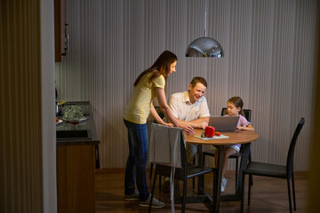 Family has gathered in dining area of hotel room