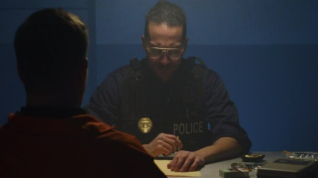Tilt up interrogation scene with cop and suspect
