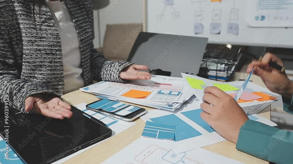 Wall mural the designer team is designing the uxui system to make the uxui system work well on new phones and s