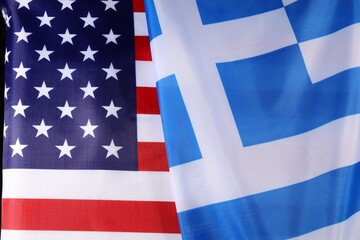 Flags of America and Greece intertwined in a united display