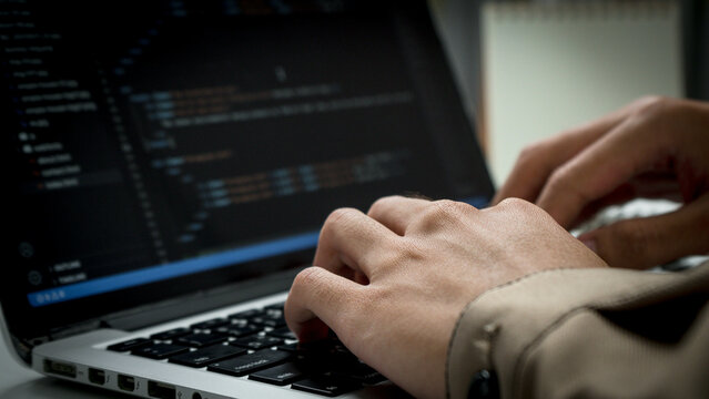 Digital technology, software development concept. Developing programmer, software developer coding computer code on laptop computer. Perfect for coding, IT solutions, applications, coding javascript