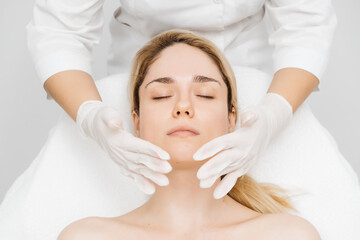 A cosmetologist applies a face cream in a modern beauty clinic, highlighting advanced skincare techniques. Ideal for showcasing premium spa treatments in your advertising.