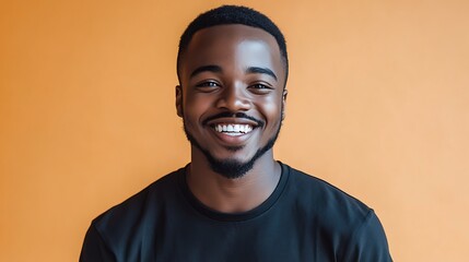 Obraz premium Joyful Musician in Black Shirt with Broad Smile against Solid Background | Vibrant Unsplash Portrait of Happy Artist