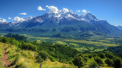 Majestic snow-capped mountain range surrounded by lush greenery. Nature and serenity concept
