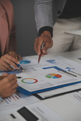 Close up of Business team analyzing income charts and graphs with modern laptop computer. Business analysis and strategy concept.