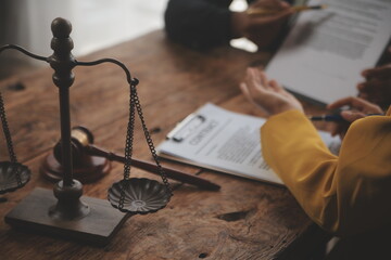 Judge gavel with Justice lawyers having team meeting at law firm background. Concepts of Law and...