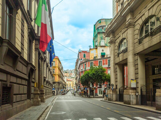 Naklejka premium Elegant avenue in downtown Naples under a cloudy sky