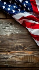Obraz premium A folded American flag draped over a rustic wooden surface, symbolizing patriotism.