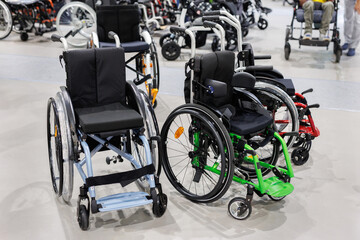 Wheelchairs with an electric motor in a store or at an exhibition.