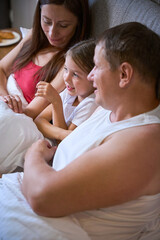 Little girl tells something to her parents