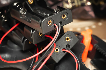 Obraz premium Battery holder. Plastic battery holder with wires and connectors close-up