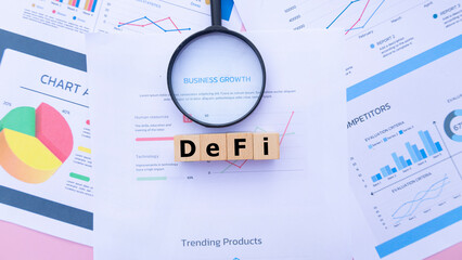 Wooden cubes with the word Defi on graph sheets, abbreviation for Decentralized Finance. Business...