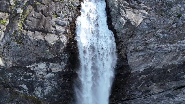 Epic waterfall in clouds zoom out drone shot, double waterfall of Mardalsfossen in Norway in 4K.