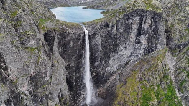Epic waterfall in clouds zoom out drone shot, double waterfall of Mardalsfossen in Norway in 4K.