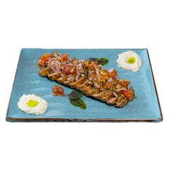 Gourmet Sliced Meat Platter Garnished with Fresh Relish and Creamy Sauces on Elegant Blue Ceramic Plate