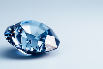 Fototapeta premium A stunning blue diamond rests gracefully on a smooth gradient surface, reflecting light through its intricate facets, highlighting its beauty and color richness