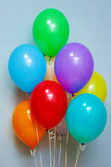 A fountain, a bunch of colorful shiny helium balloons.