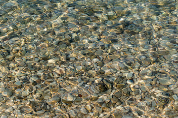 Arid rocky landscape with few backlit tufts of grass
