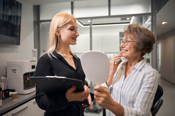 Patient admires her smile in the mirror